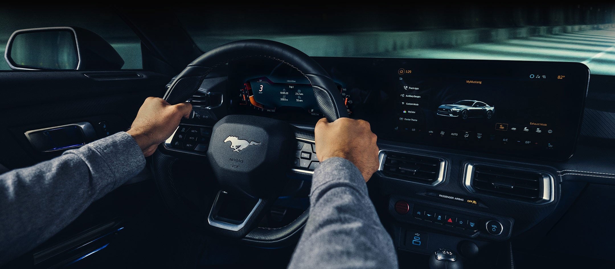 A 2024 Ford Mustang® model interior with a person driving | Tubbs Brothers, Inc in Sandusky MI