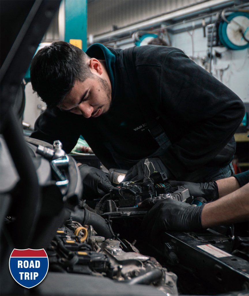 Man working under the hood of vehicle