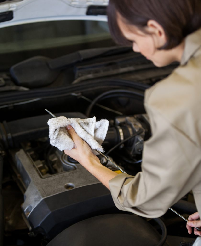 Tubbs Brothers - women checking engine oil