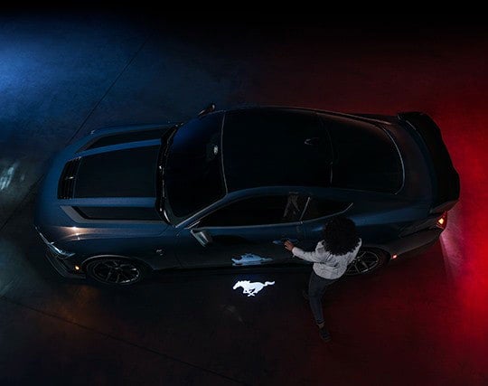 2024 Ford Mustang® Dark Horse™ model with a driver approaching the vehicle | Tubbs Brothers, Inc in Sandusky MI